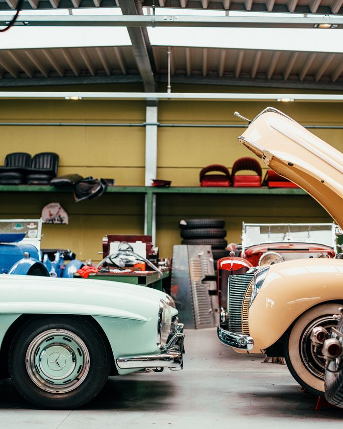 Crafting Captivating Headlines: Your awesome post title goes here Explore classic cars inside a vintage auto workshop with retro interiors and open hoods.